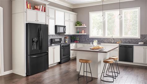 pictures of black stainless steel appliances with white cabinets|black fridge in white kitchen.